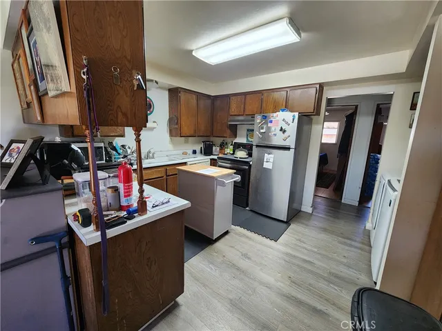 a kitchen with refrigerator and cabinets