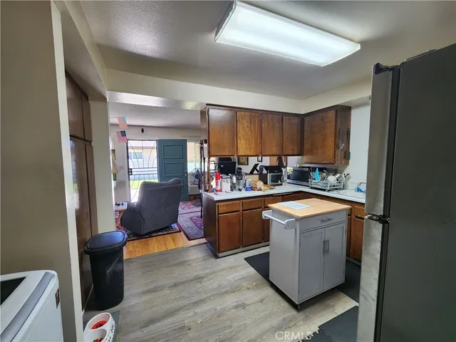 a kitchen with a refrigerator and a stove top oven