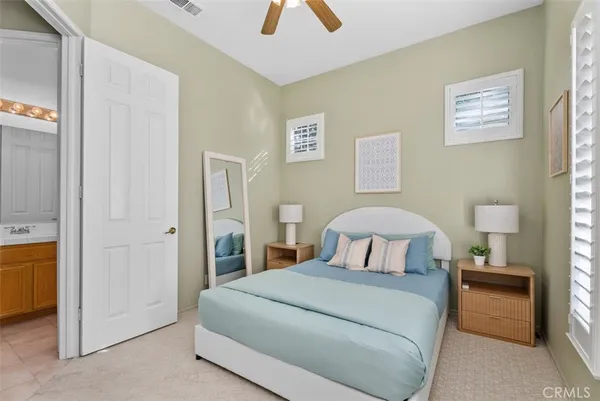 a bedroom with a bed and a lamp