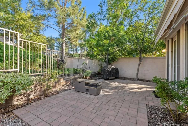 a view of a backyard with plants and a bench