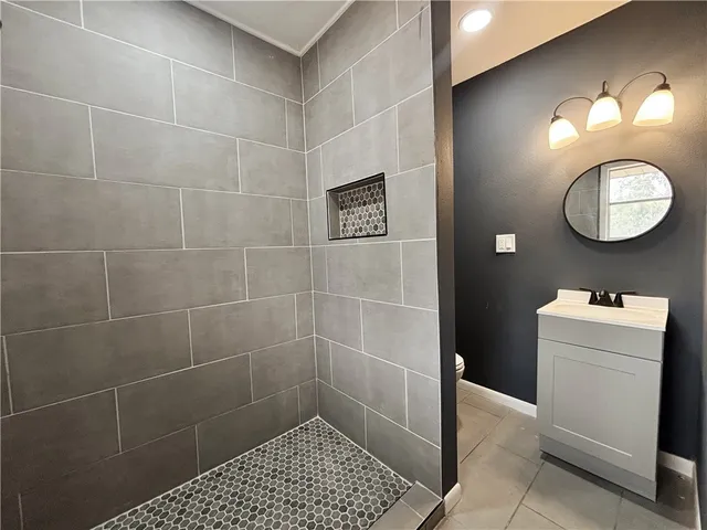 a bathroom with a toilet a sink and a mirror