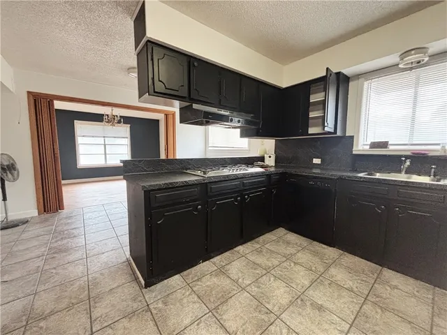 a kitchen with a sink stove and microwave