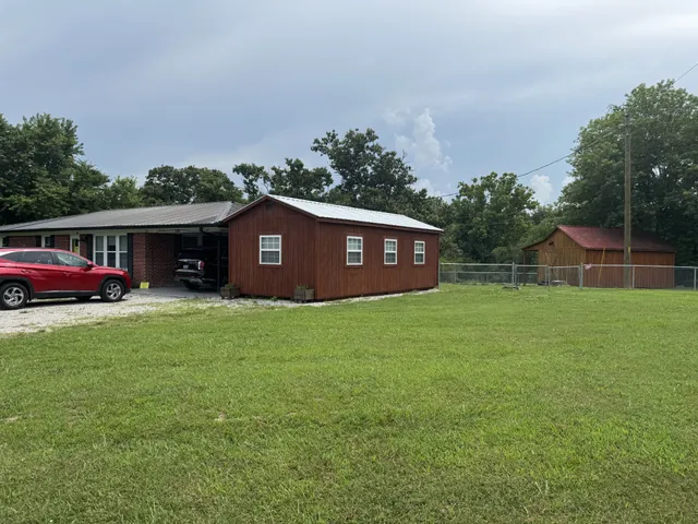 a view of a house with a garden and yard