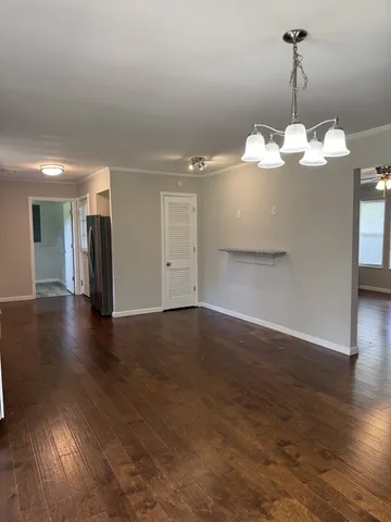 a view of a room with wooden floor