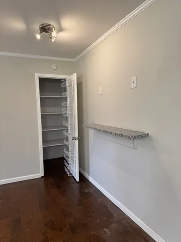 a view of walk in closet with empty racks