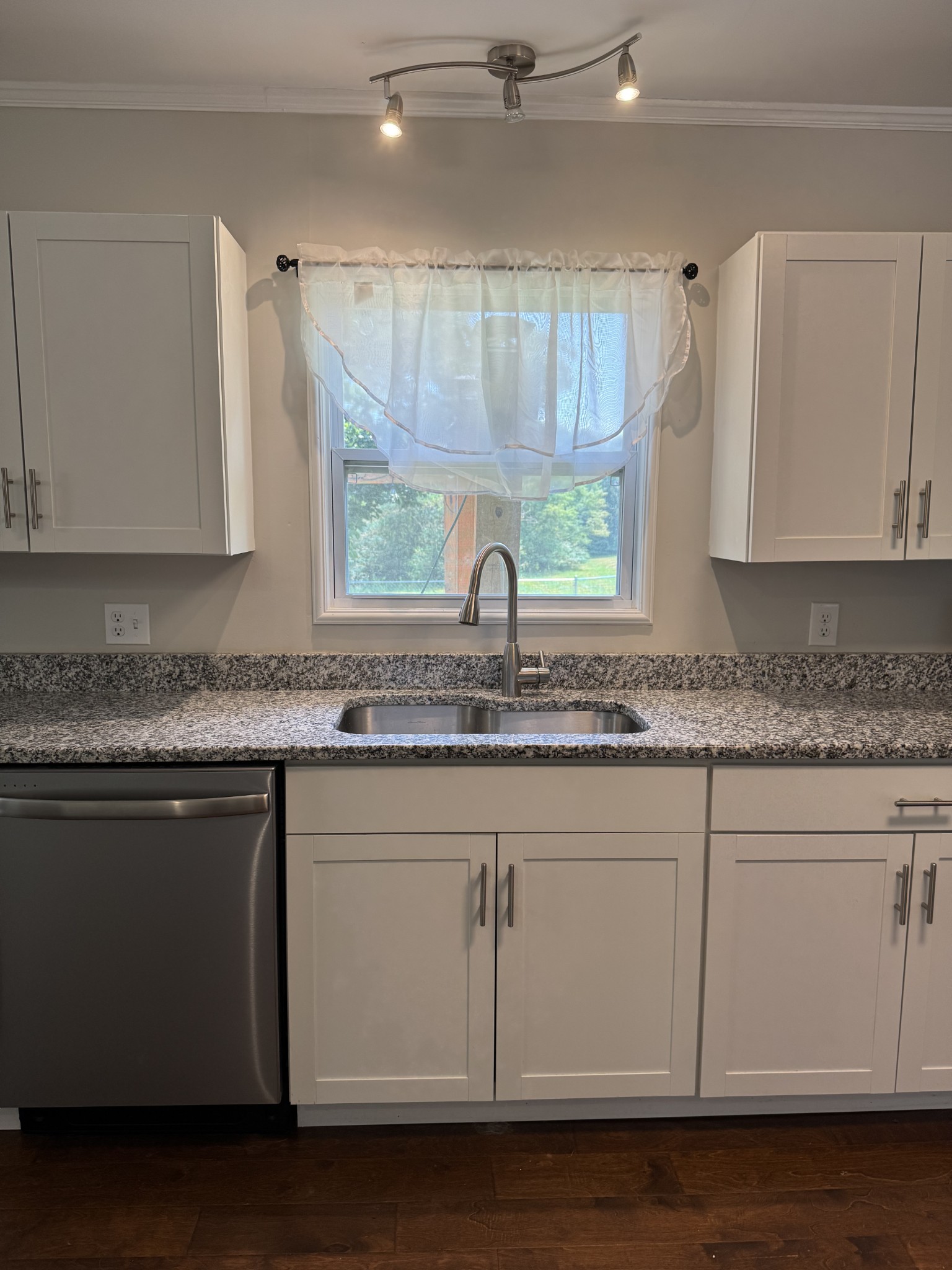 8298 Southfork Road Baxter, TN 38544 - Photo 19 of 49 a kitchen with granite countertop cabinets stainless steel appliances a sink and a window