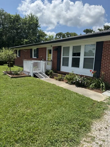 a front view of a house with a yard