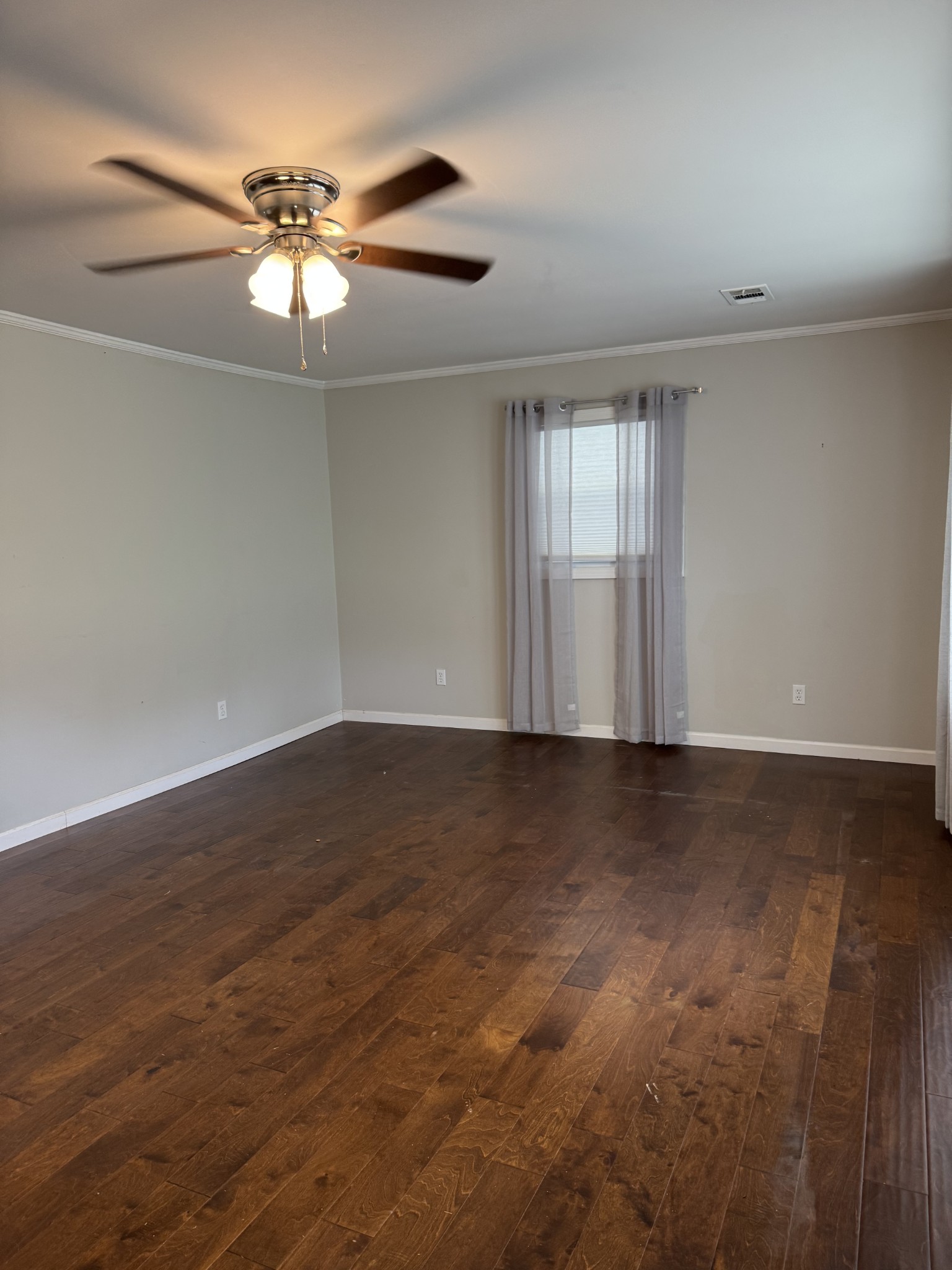 8298 Southfork Road Baxter, TN 38544 - Photo 22 of 49 an empty room with wooden floor fan and windows