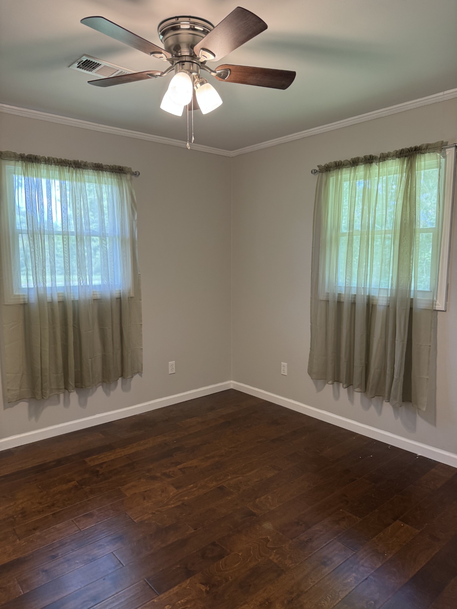 8298 Southfork Road Baxter, TN 38544 - Photo 26 of 49 an empty room with wooden floor fan and windows