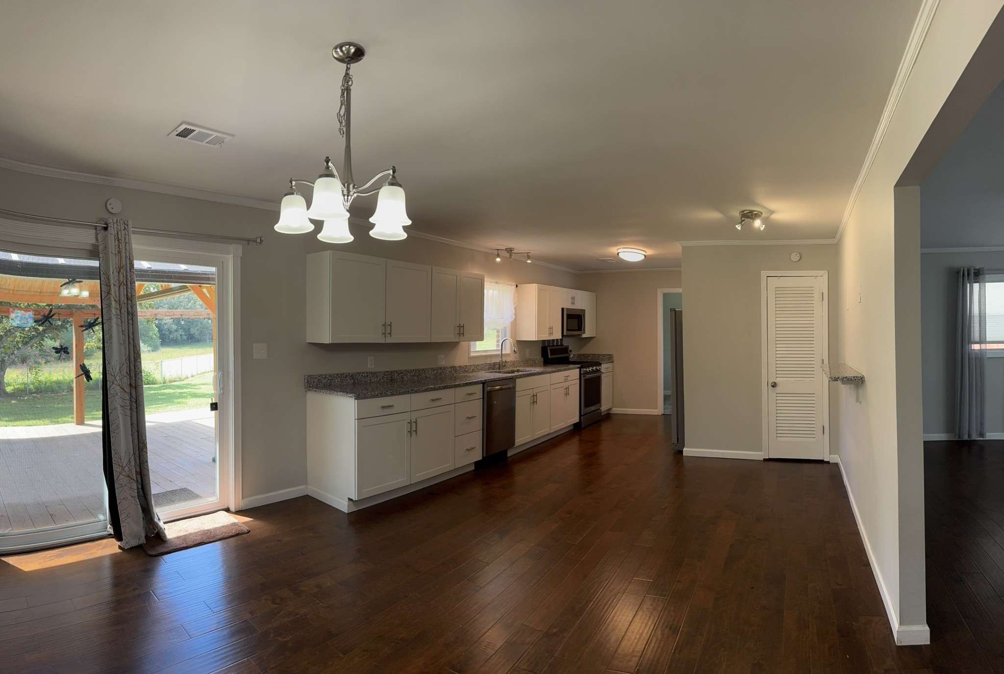 8298 Southfork Road Baxter, TN 38544 - Photo 37 of 49 a kitchen with stainless steel appliances granite countertop a refrigerator a stove and a wooden floors
