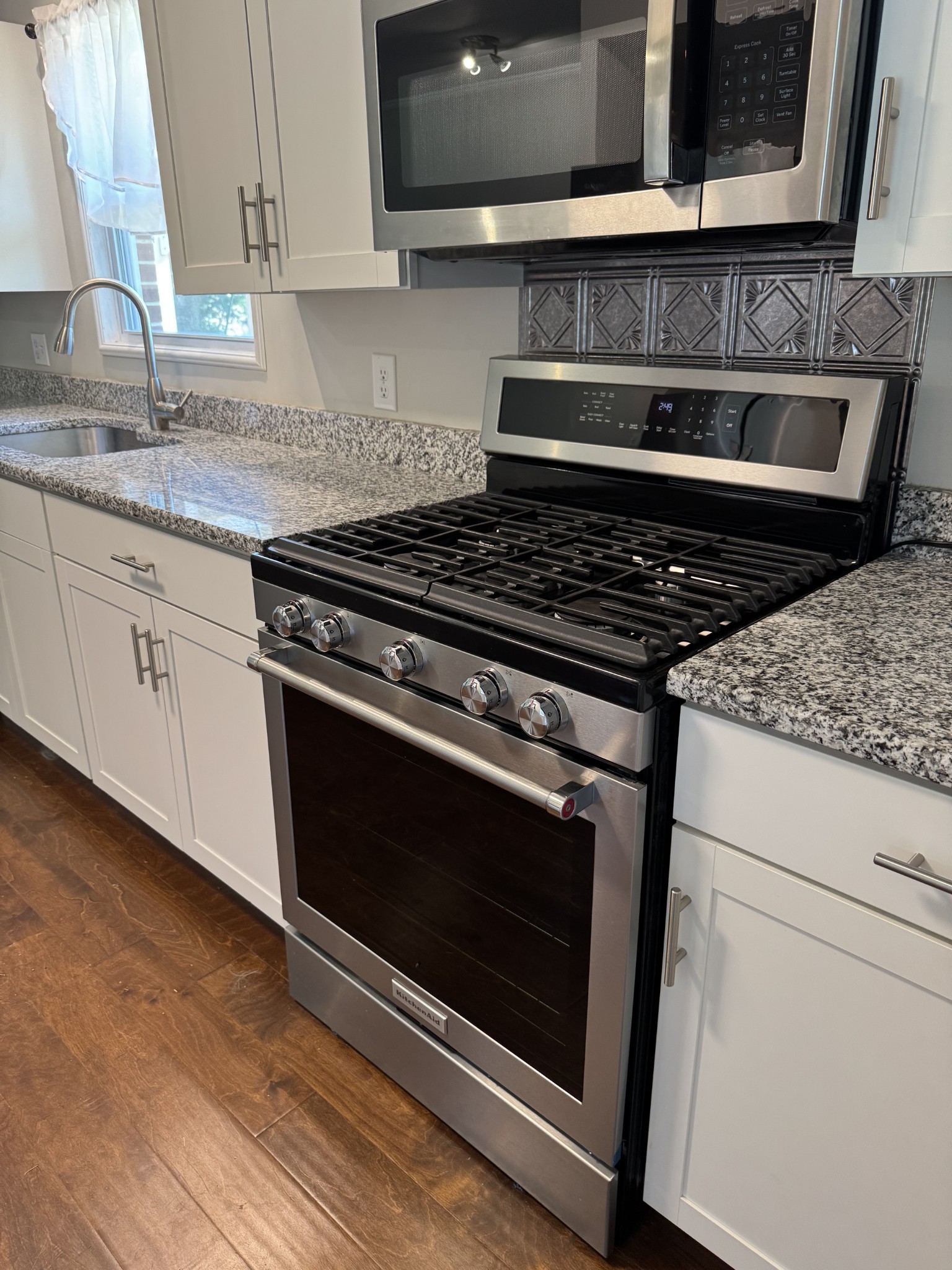 8298 Southfork Road Baxter, TN 38544 - Photo 39 of 49 a kitchen with granite countertop a stove and a microwave