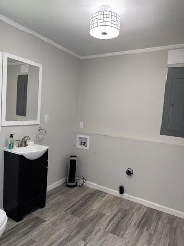 a bathroom with a toilet a sink and a window