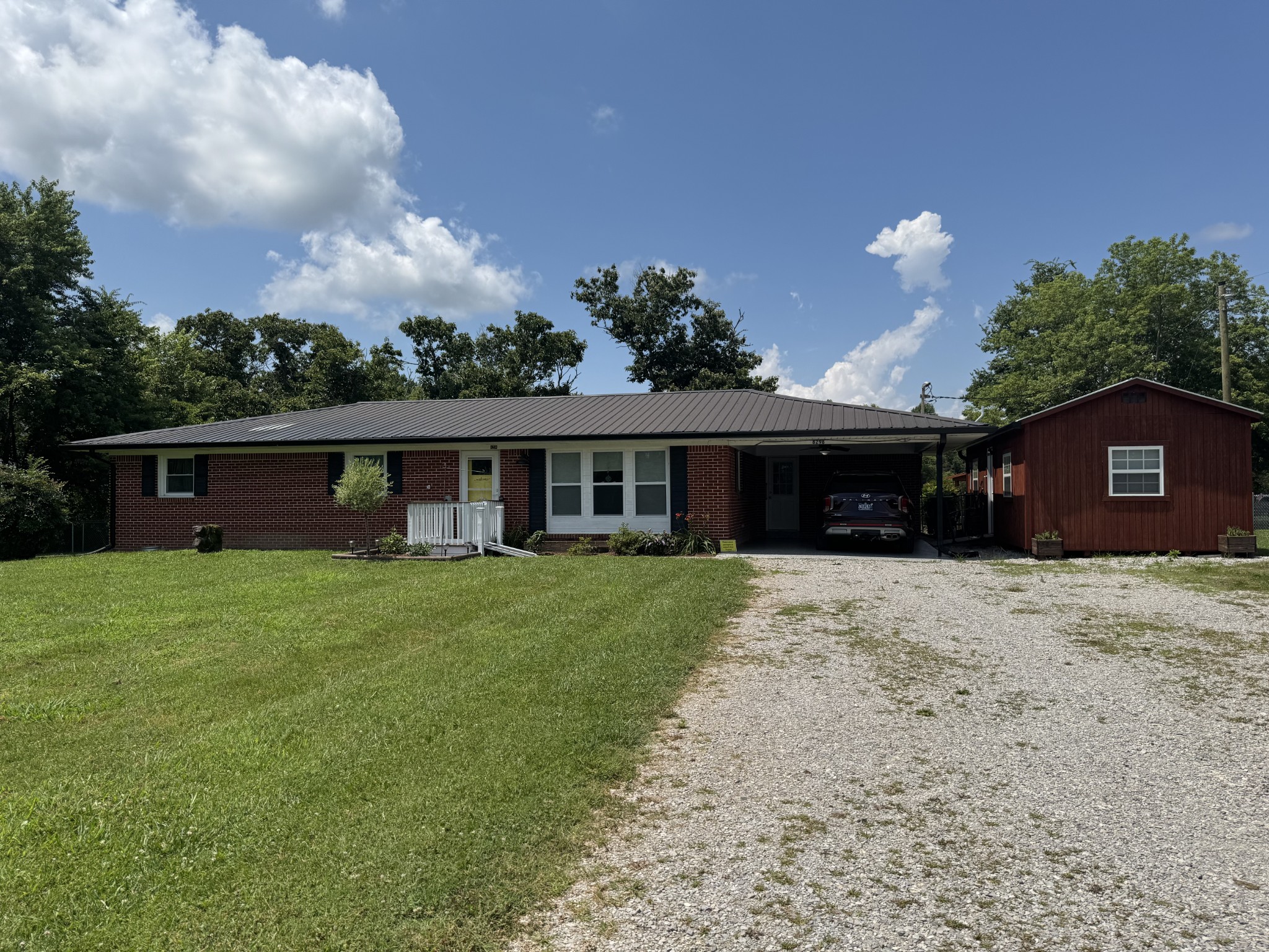 8298 Southfork Road Baxter, TN 38544 - Photo 4 of 49 a front view of a house with a garden and trees