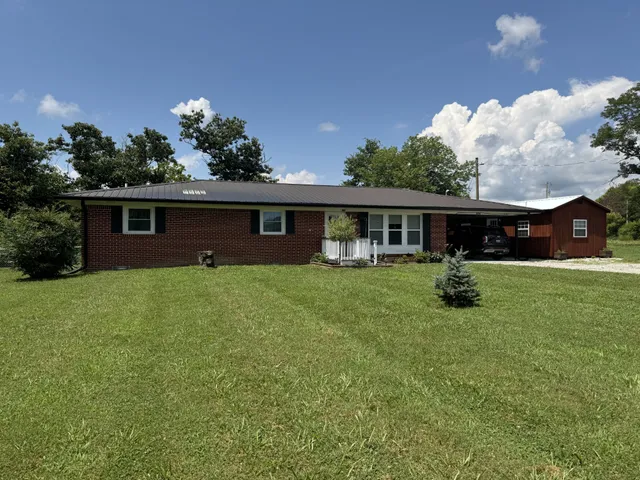 a front view of house with yard and green space