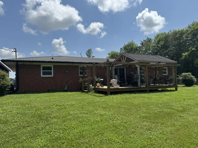 a view of a house with backyard porch and garden