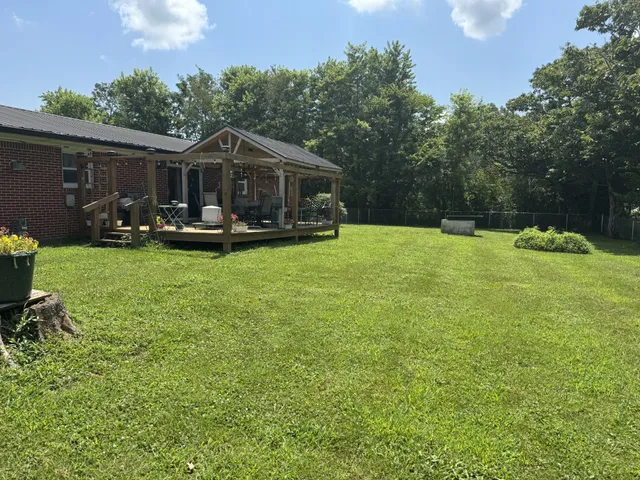 a front view of a house with garden and sitting area
