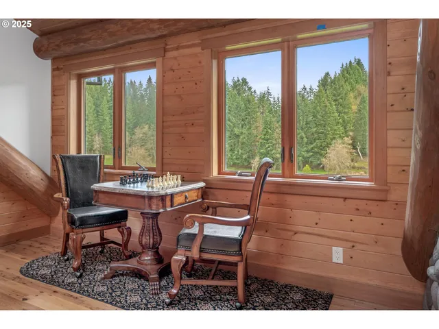 a view of a living room and a floor to ceiling window and wooden floor