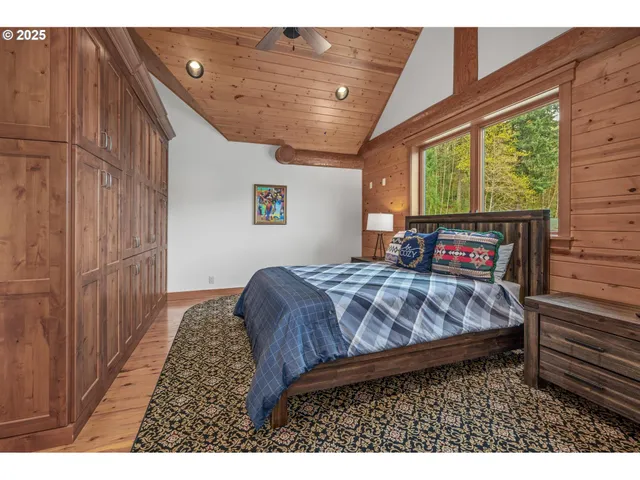 a bathroom with a granite countertop double vanity sink a mirror and a bathtub