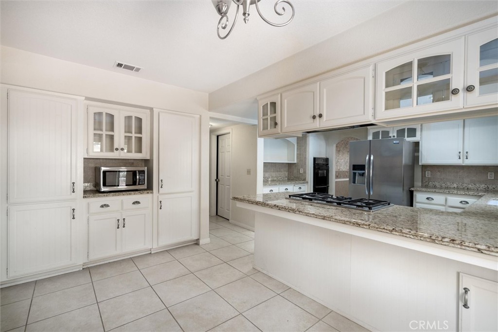 34150 Stowe Road Winchester, CA 92545 - Photo 8 of 80 a kitchen with stainless steel appliances granite countertop a sink and cabinets