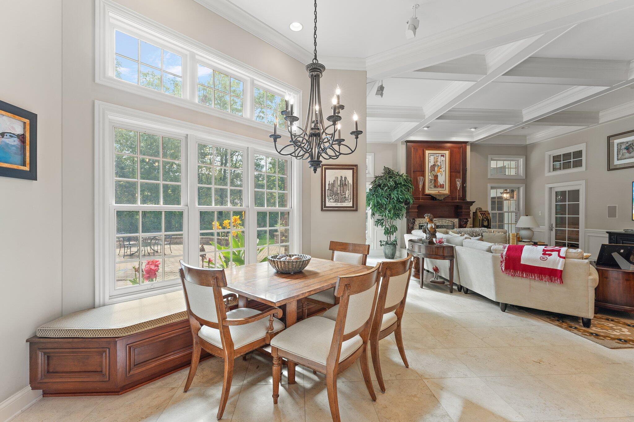 1191 Churchill Lane Crown Point, IN 46307 - Photo 16 of 80 a dining room with furniture a chandelier and a rug