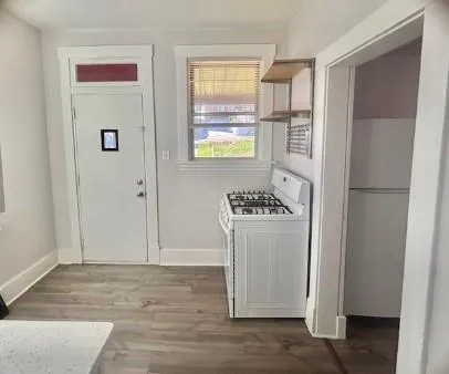 a view of kitchen with furniture and refrigerator