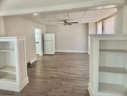 a view of a room with wooden floor and staircase