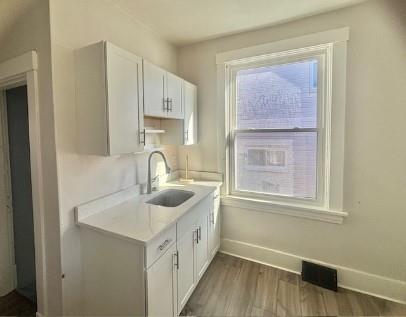 2992 Ruthwood Avenue Pittsburgh, PA 15227 - Photo 8 of 11 a kitchen with a sink stove and cabinets