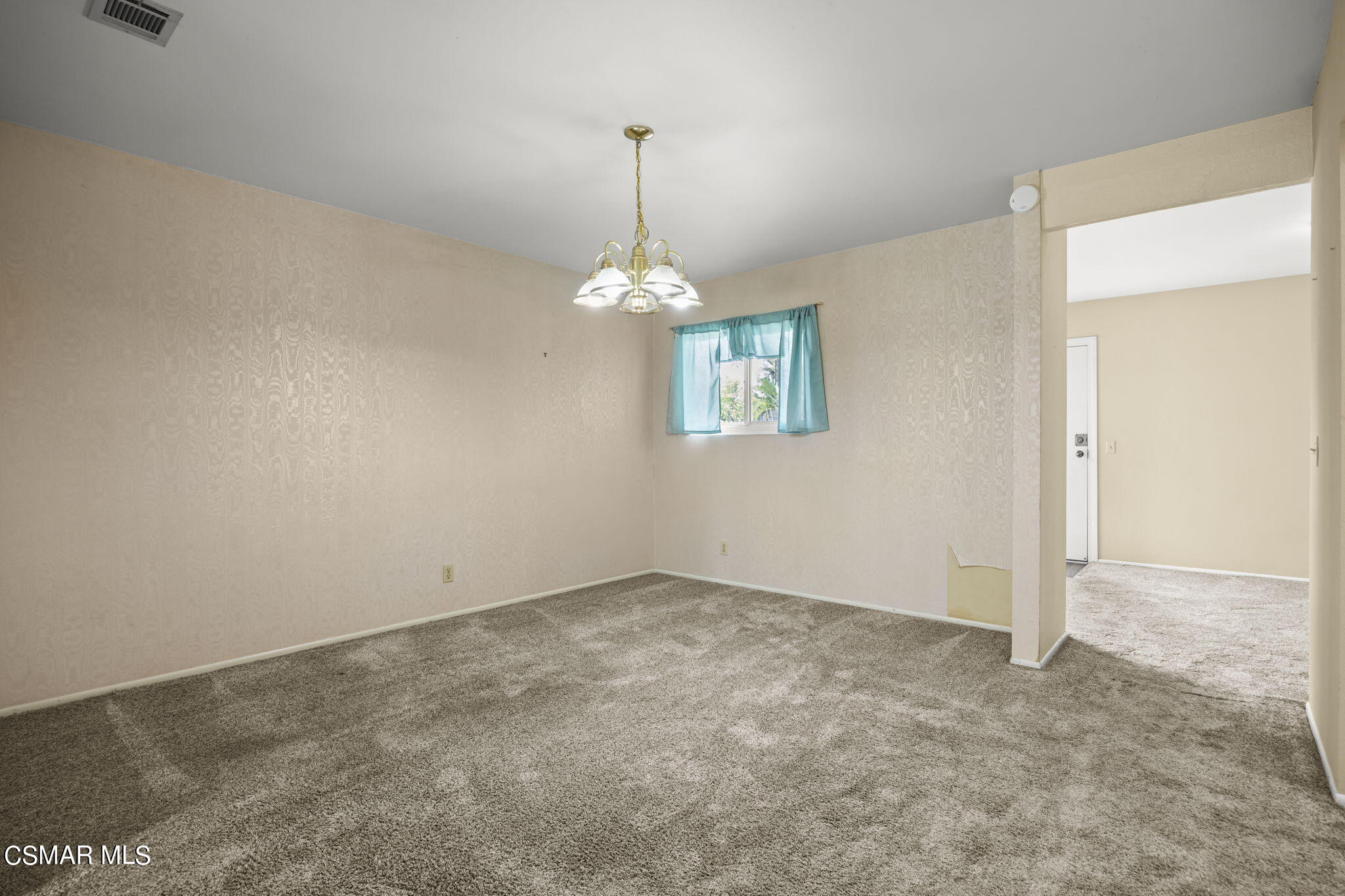3601 Ketch Avenue Oxnard, CA 93035 - Photo 14 of 37 an empty room with windows and chandelier
