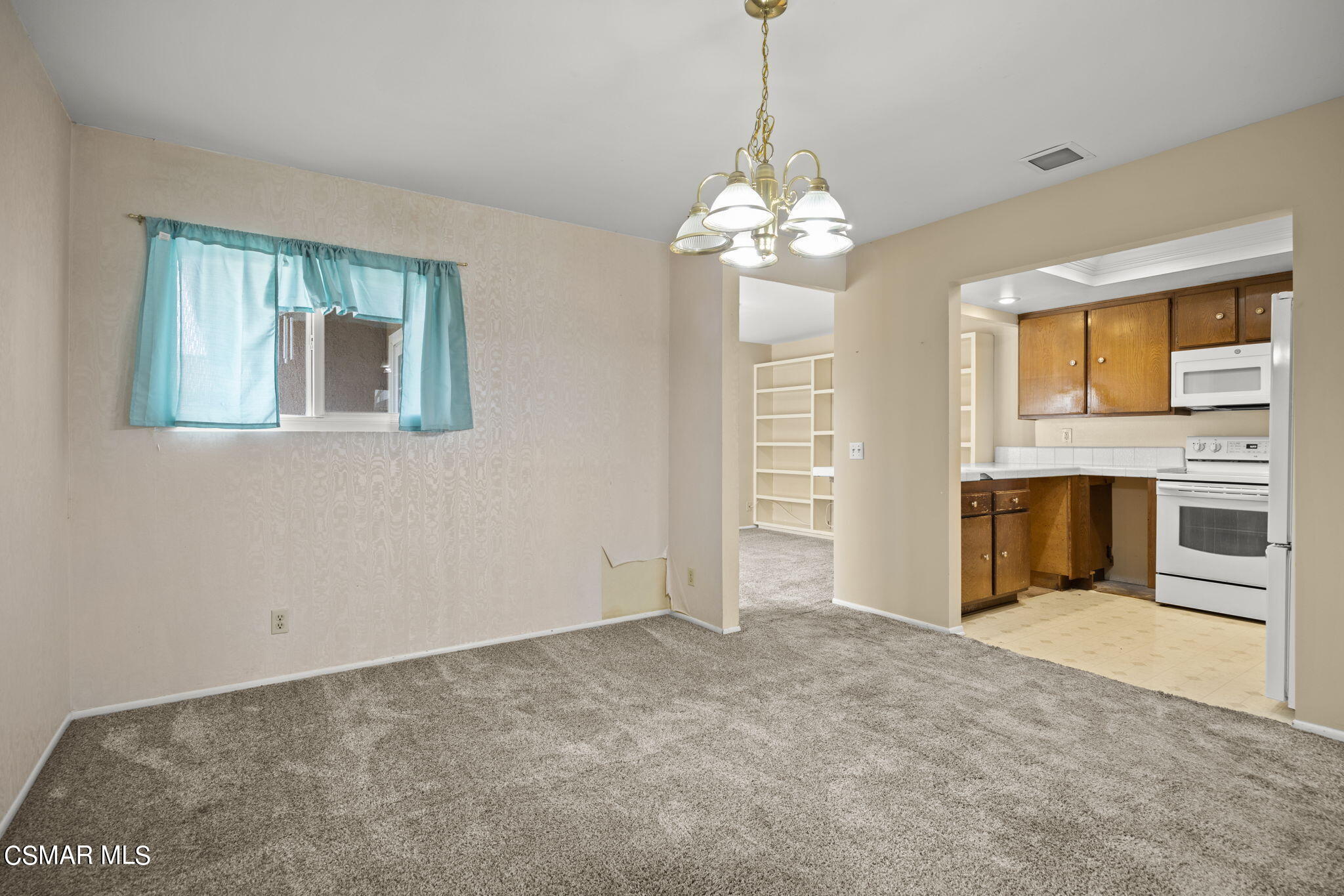 3601 Ketch Avenue Oxnard, CA 93035 - Photo 15 of 37 a view of a livingroom with a chandelier fireplace and windows