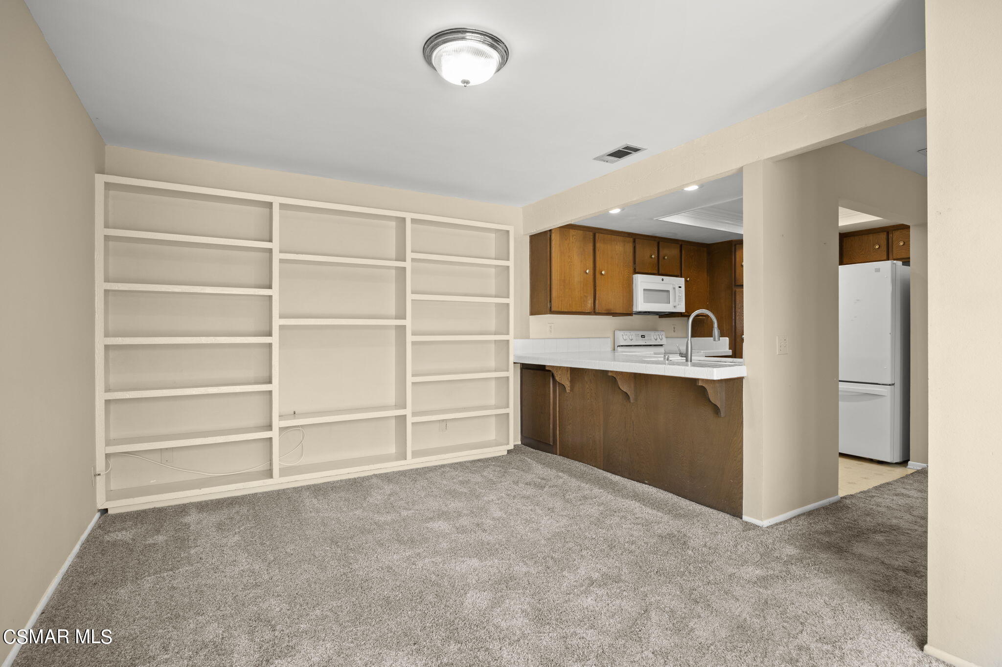 3601 Ketch Avenue Oxnard, CA 93035 - Photo 22 of 37 a view of an empty room with a kitchen and a window
