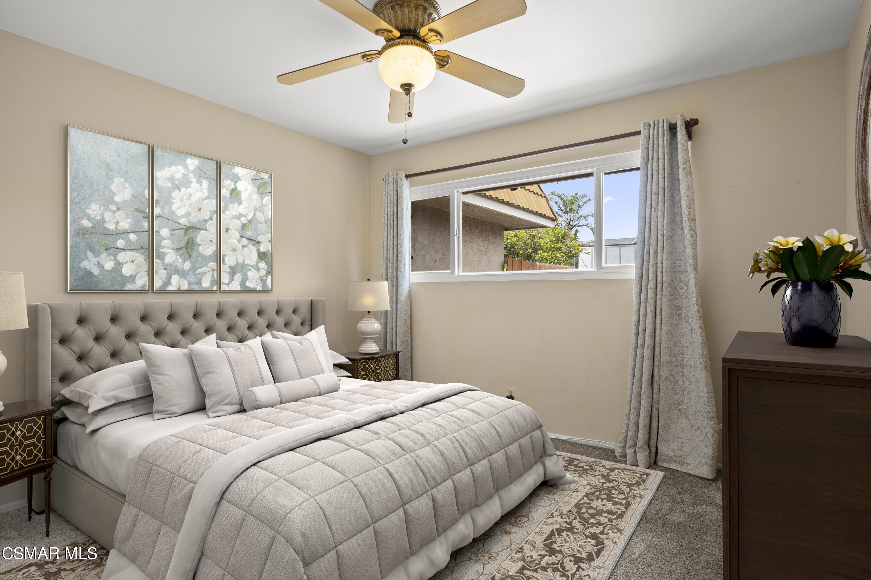 3601 Ketch Avenue Oxnard, CA 93035 - Photo 26 of 37 a bedroom with a large bed and a chandelier