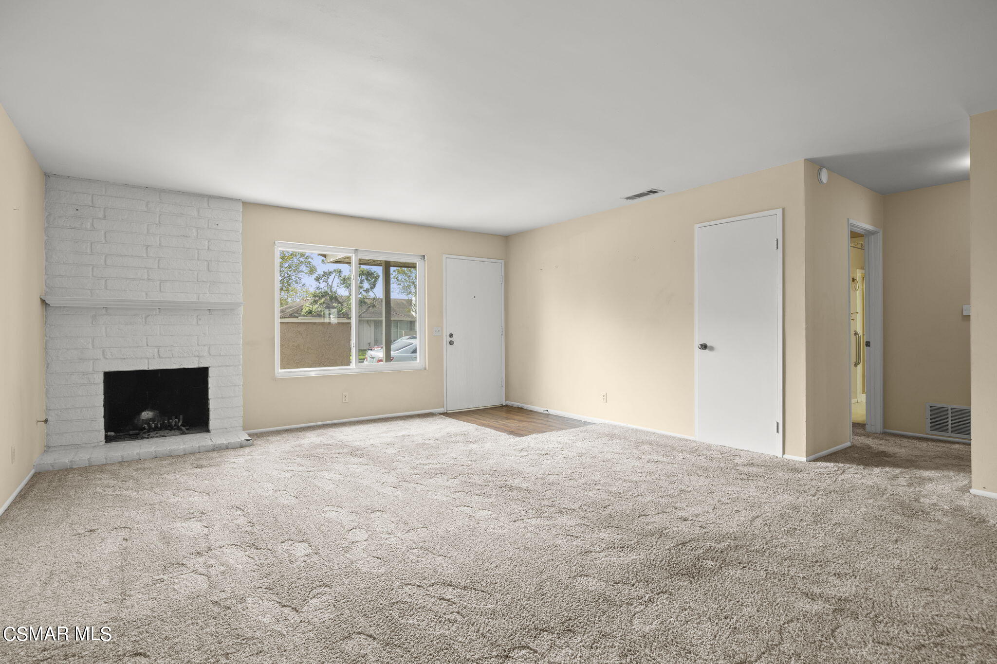 3601 Ketch Avenue Oxnard, CA 93035 - Photo 7 of 37 a view of an empty room with a fireplace and a window
