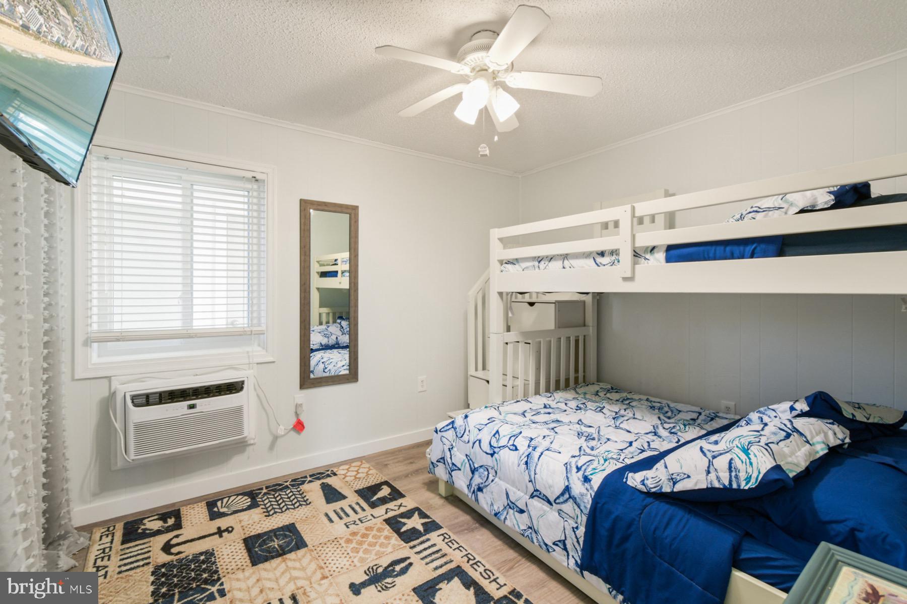 722 Mooring Road, Unit A104 Ocean City, MD 21842 - Photo 21 of 33 a bedroom with a bed and a chandelier
