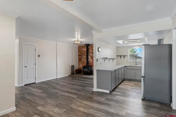 a kitchen with a refrigerator and a sink
