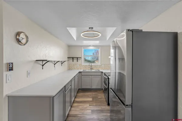 a kitchen with stainless steel appliances a refrigerator and a sink