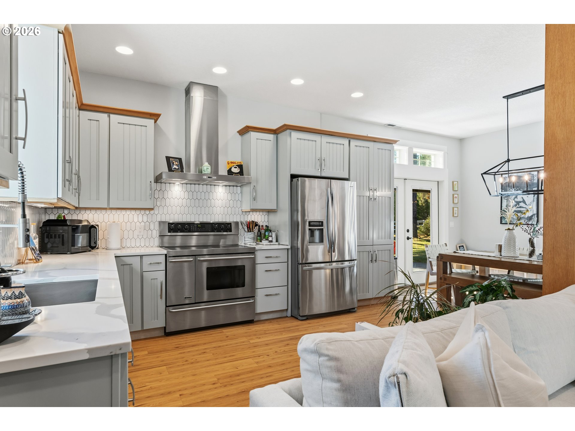 4 Westside Road Trout Lake, WA 98650 - Photo 14 of 45 a kitchen with stainless steel appliances kitchen island granite countertop a refrigerator oven a sink dishwasher and white cabinets with wooden floor