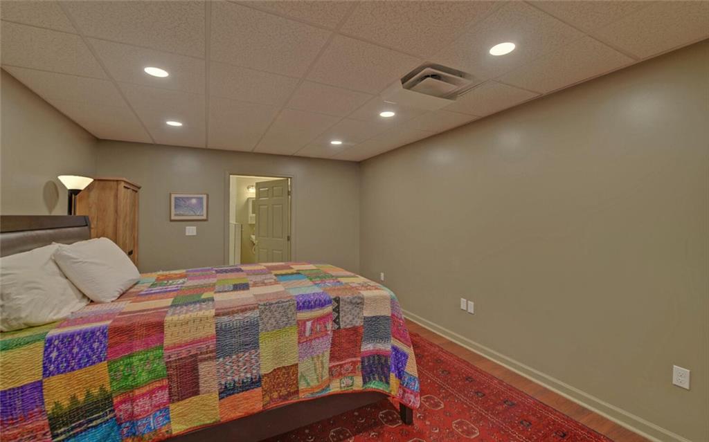 3644 Maple Forge Lane Gainesville, GA 30504 - Photo 31 of 49 a bedroom with a bed and wooden floor