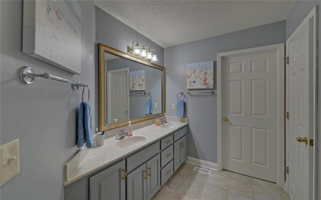 3644 Maple Forge Lane Gainesville, GA 30504 - Photo 42 of 49 a bathroom with a double vanity sink and a mirror