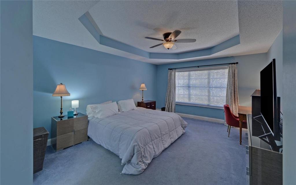 3644 Maple Forge Lane Gainesville, GA 30504 - Photo 44 of 49 a bedroom with a bed a window and gym equipment