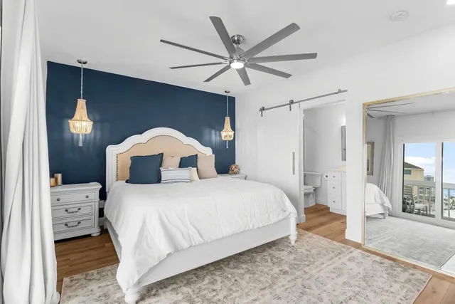 a bedroom with a bed and a large mirror