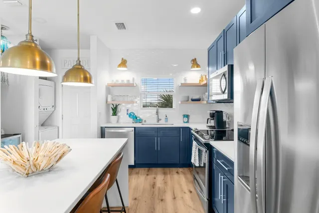 a kitchen with a sink a refrigerator and a stove