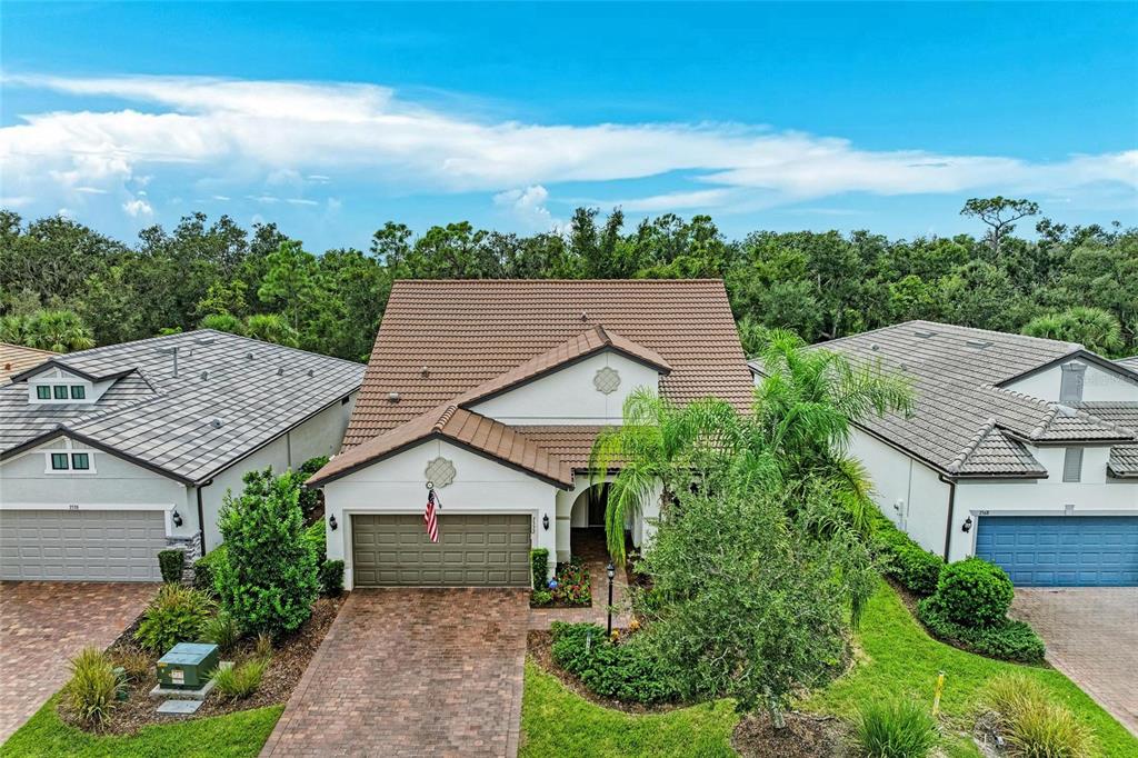 7572 Viola Loop Bradenton, FL 34202 - Photo 2 of 65 an aerial view of a house with yard and mountain view in back