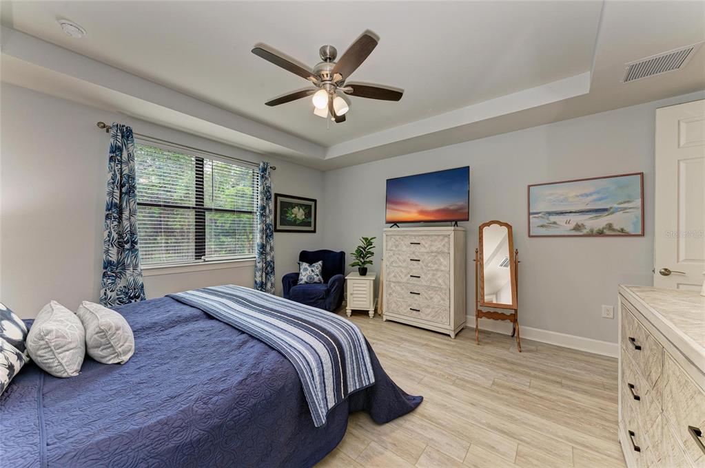 7572 Viola Loop Bradenton, FL 34202 - Photo 27 of 65 a bedroom with a bed and wooden floor