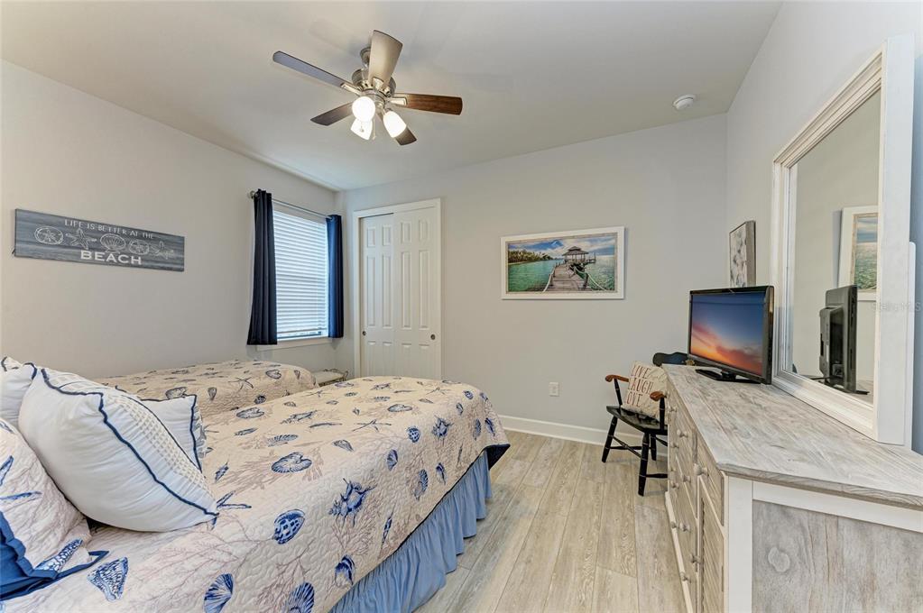 7572 Viola Loop Bradenton, FL 34202 - Photo 32 of 65 a bedroom with a bed and a flat screen tv