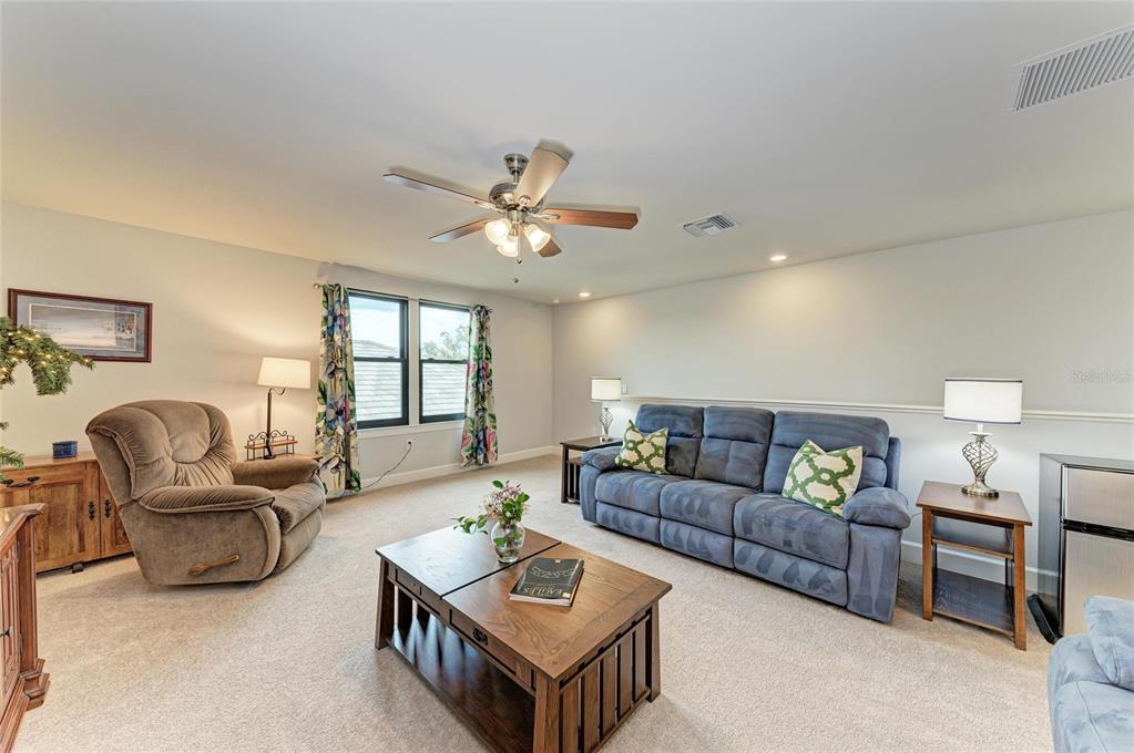 7572 Viola Loop Bradenton, FL 34202 - Photo 36 of 65 a living room with furniture ceiling fan and a window