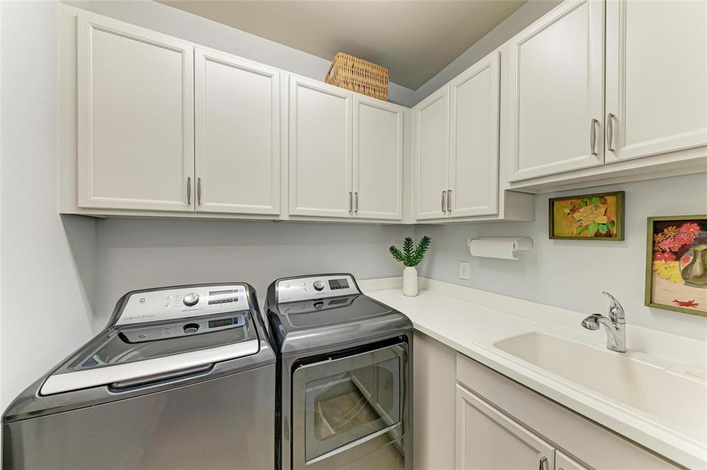 7572 Viola Loop Bradenton, FL 34202 - Photo 41 of 65 a utility room with stainless steel appliances granite countertop a sink and a stove