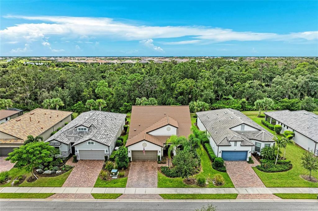 7572 Viola Loop Bradenton, FL 34202 - Photo 49 of 65 an aerial view of a house with garden space and street view
