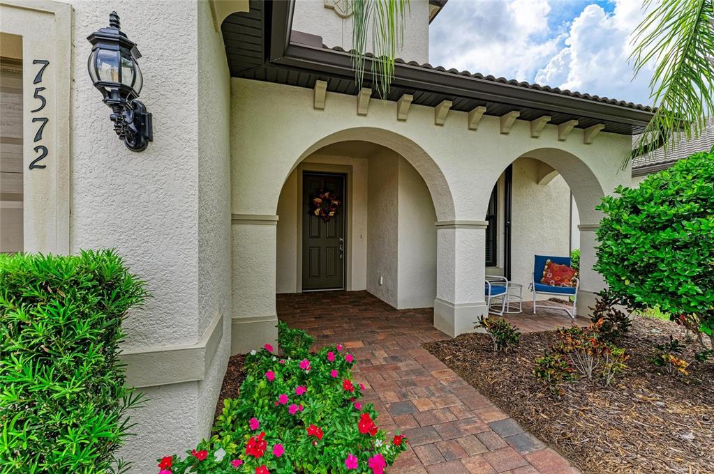 7572 Viola Loop Bradenton, FL 34202 - Photo 6 of 65 a front view of a house with plants