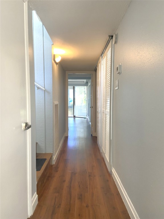 108 World Of Tennis Square, Unit 108C Lakeway, TX 78738 - Photo 13 of 25 a view of hallway with wooden floor