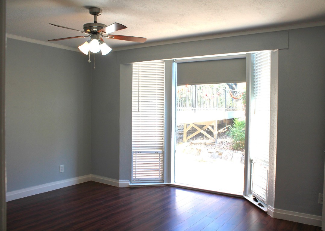 108 World Of Tennis Square, Unit 108C Lakeway, TX 78738 - Photo 14 of 25 a view of an empty room with wooden floor and a window